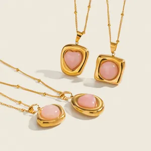 Detailed macro view of premium stainless steel necklaces with pink heart and round pendants