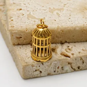 Detailed macro view of a gold-colored stainless steel birdcage pendant for DIY jewelry.