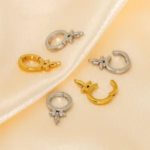 Macro detail shot of gold and silver stainless steel oval jewelry clasps on satin