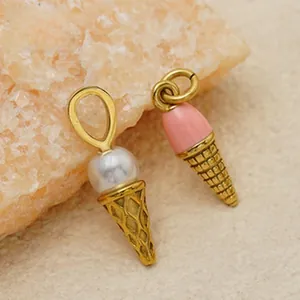 Macro view of pink enamel and white pearl ice cream cone charms for jewelry making