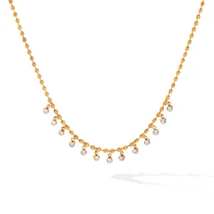 Close-up detail of 18K gold-plated titanium steel necklace with zircon dangles