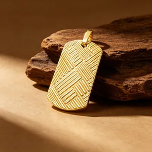 Close-up of gold titanium steel dog tag pendant with 3D cross-hatched texture pattern