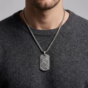 Detail view of men's titanium steel military tag necklace with interlaced diagonal texture