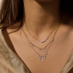 Close-up of three-layer 18K gold plated necklace with shimmering zircon tassels