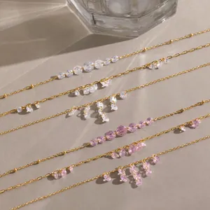 Detail of 18K gold plated stainless steel necklaces with pink and white zirconia tassels