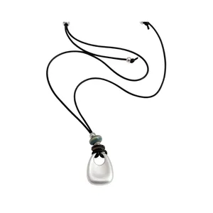 Minimalist silver geometric pendant necklace featuring black cord and accent beads detail