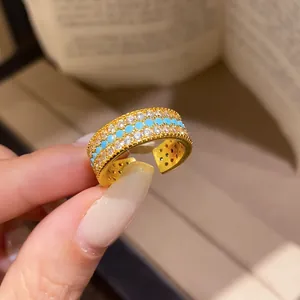Detailed close-up of a vintage palace style gold ring with zircon and turquoise beads