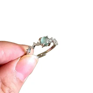 Vintage silver open ring with light blue gemstone and shimmering zircon accents.