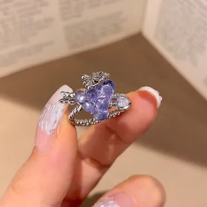 Detailed view of vintage zircon ring with purple grape-like beads and silver textured band