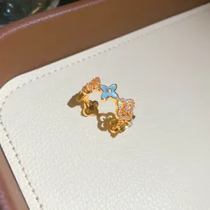 Close-up of a vintage gold-toned ring with blue enamel clover and zircon details