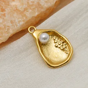 Irregular textured 316 stainless steel pendant with pearl inlay in 14k gold finish