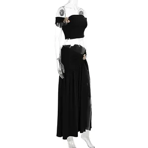 Chic black two-piece beach set featuring a crop top and pleated side-slit long skirt