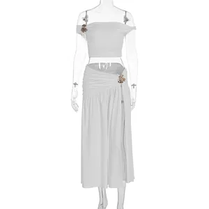 Elegant white two-piece set featuring ruched off-shoulder top and high-slit long skirt