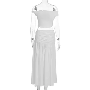 Front detail of white two-piece beach set featuring off-shoulder top and pleated maxi skirt