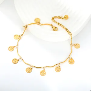 Gold stainless steel anklet featuring multiple delicate smiley face charms on a wavy chain