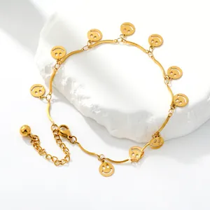 Detailed view of a golden stainless steel anklet featuring multiple smiley face charms