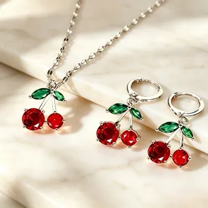 Detailed view of cherry jewelry set featuring red faceted stones and silver finish