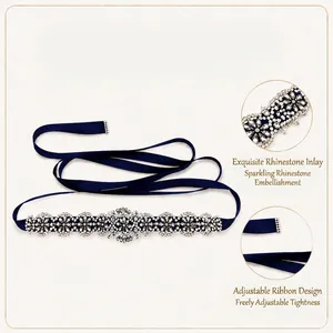 Macro view of hand-sewn crystal rhinestone flower pattern on a navy blue satin ribbon belt