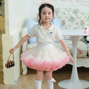 Adorable young girl wearing a fluffy pink and white tiered mesh tutu skirt outfit