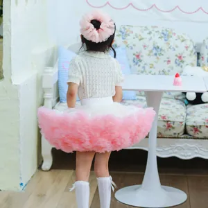 Back view of a very fluffy layered pink and white mesh tutu skirt for toddlers and girls