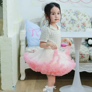 Detailed side view showing the volume of a fluffy pink and cream girl's mesh tutu skirt