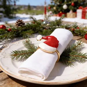 Festive Santa hat napkin ring with red enamel and gold finish for Christmas table decor.
