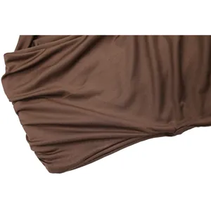 Gros plan sur un tissu élastique marron montrant la texture et le drapé soyeux