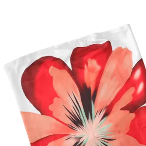Detailed macro shot showing the vibrant red floral print on a white strapless maxi dress.