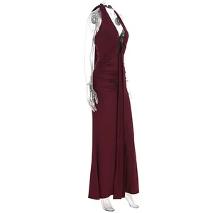 Side view of an elegant burgundy halter backless maxi dress with ruched details.