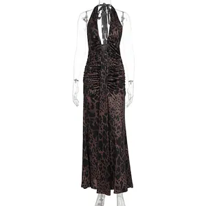 Detailed view of backless leopard print halter dress with elegant ruched design