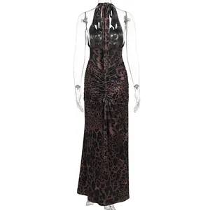 Back view of an elegant leopard print halter dress with ruched detail and open back.