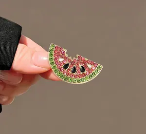 Detailed macro view of a bitten watermelon slice brooch with pink and green rhinestones