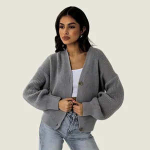 Close-up view of loose grey ribbed knit cardigan with large buttons for autumn winter fashion