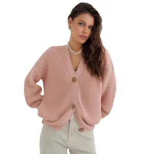 Elegant pink loose knitted cardigan for women in a cozy macaron style for winter
