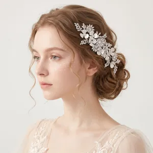 Exquisite detail of a handmade bridal hair comb featuring clay flowers and rhinestones