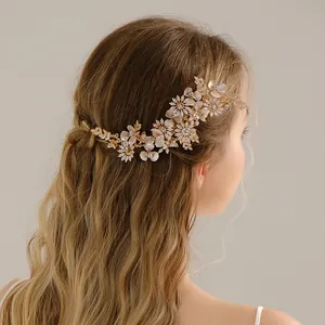 Elegant bridal hair comb with rhinestones and handmade flowers on wavy model's hair