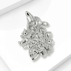 Back detail view of silver-toned sheep brooch showing pin and safety clasp mechanism