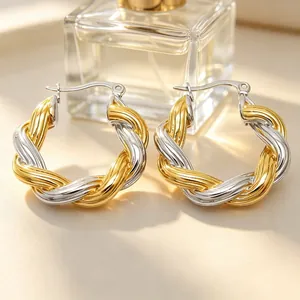 Elegante Nahaufnahme von gedrehten Creolen mit zweifarbigem Gold- und Silber-Finish