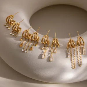 Detailed view of assorted 18K gold-plated C-shaped earrings with zircons and tassels