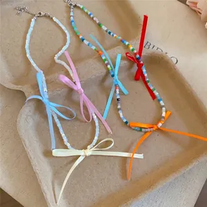 Colorful dopamine beaded necklace with vibrant ribbon bows for a summer look