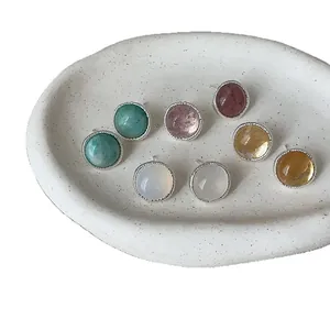 Vintage silver needle round stud earrings with colorful agate stones on white tray