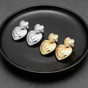 Vintage quilted double heart stud earrings in gold and silver stainless steel finishes.