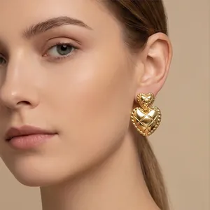 Vintage quilted gold heart stud earrings for women, chic French style jewelry accessory.