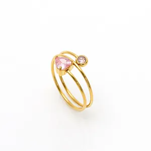 Detail of triple-layer gold stainless steel ring with pink heart and round zircons