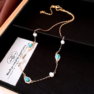 Dainty gold plated necklace featuring genuine freshwater pearls and turquoise charms