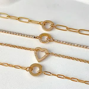 Close-up of gold stainless steel bracelets with heart and ring charms