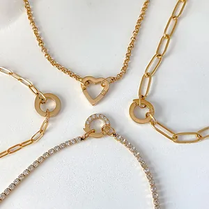 Detail view of various gold-plated stainless steel chains with unique clasps