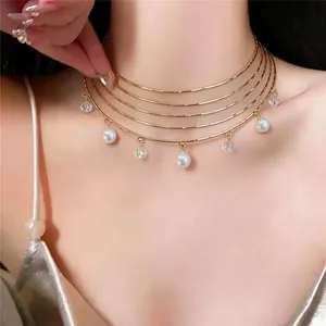 Elegant multi-layer gold choker necklace with white pearls and crystal charms