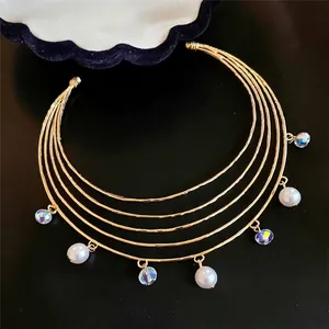 Elegant multi-layer gold choker necklace with white pearls and iridescent crystals