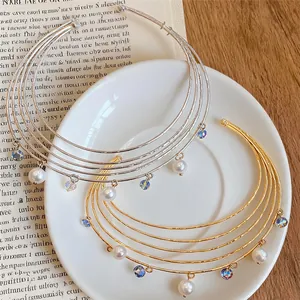 Detailed view of elegant multi-layered gold and silver chokers with pearls and crystals